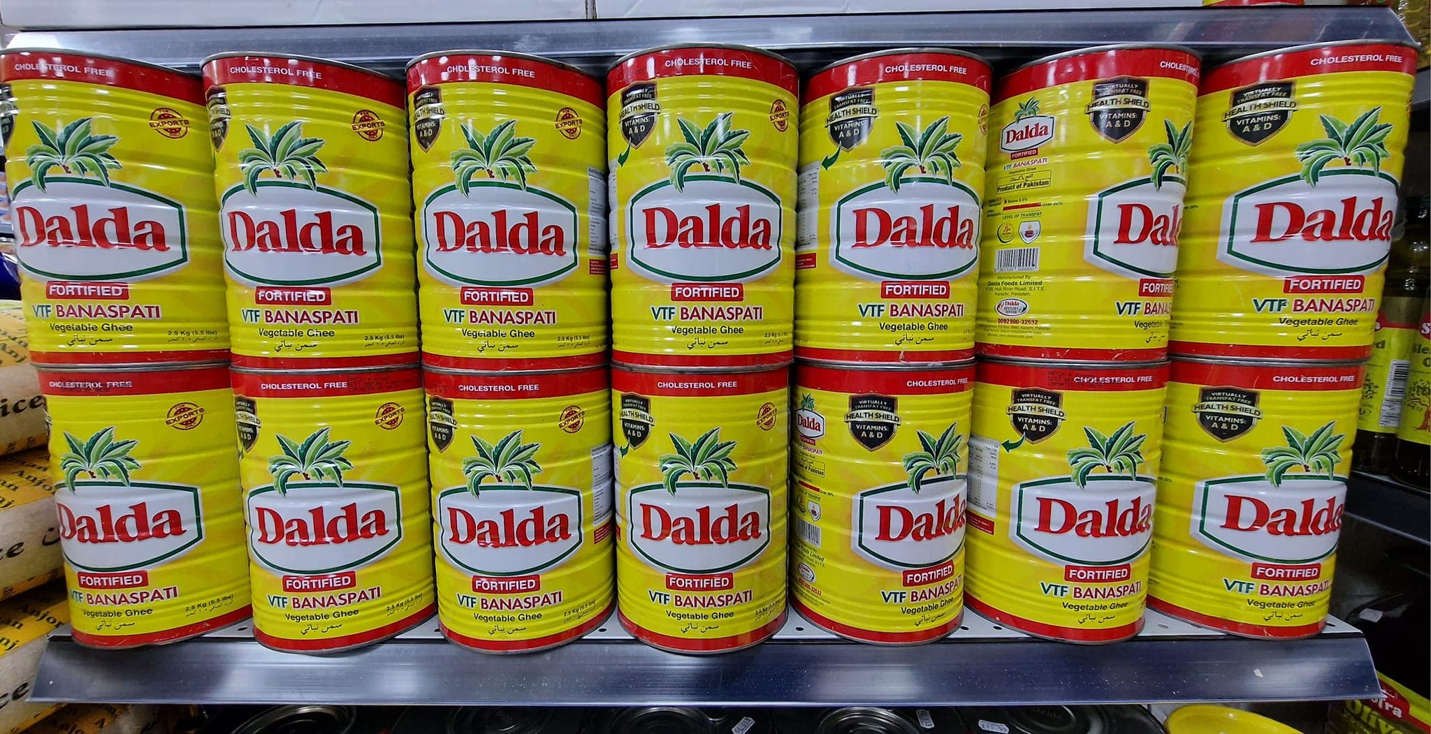 Branded ghee tins on shelf in Pakistan, typical electrolytic tinplate packaging for edible oils